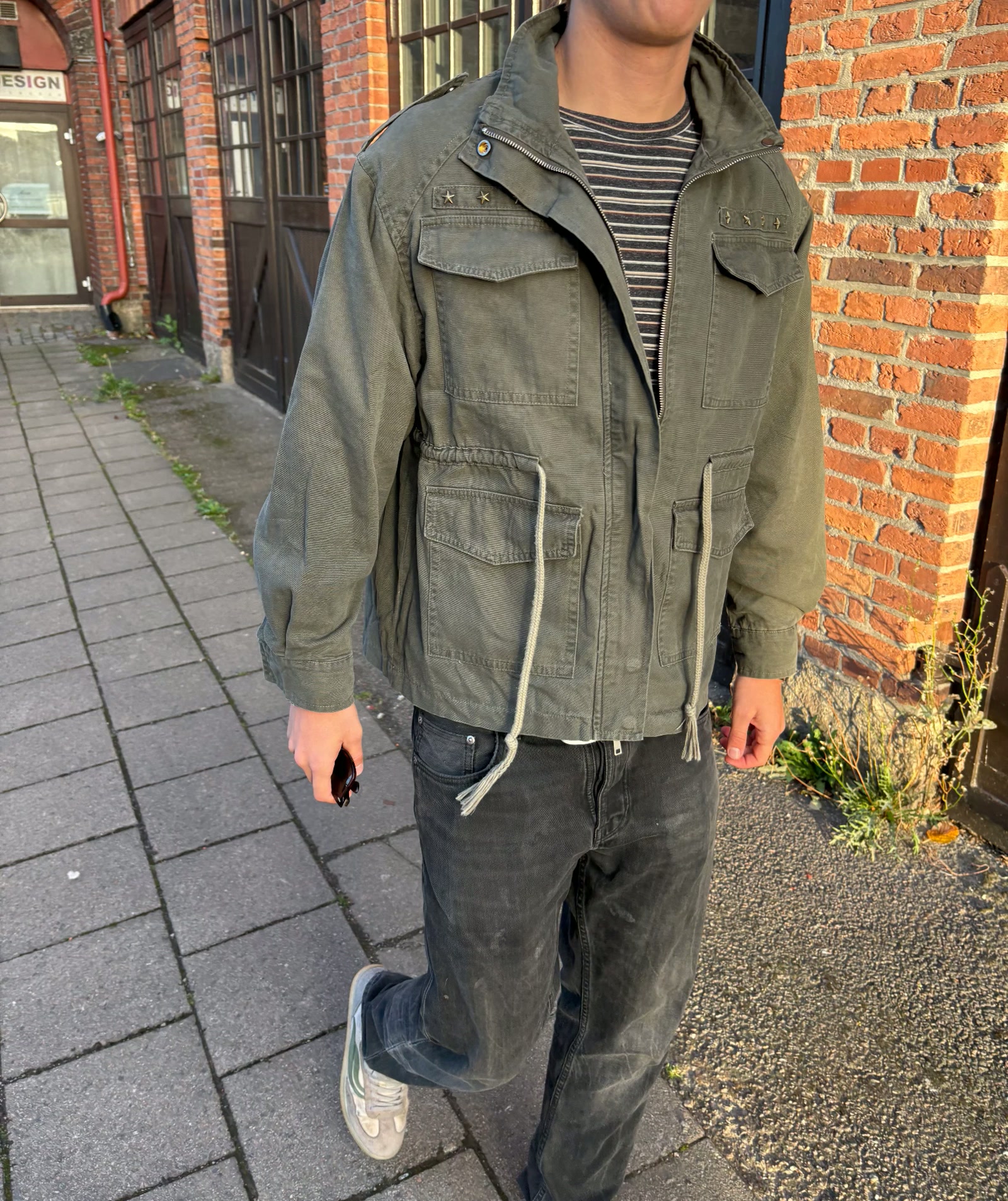 Model wearing the Star Field Jacket on a city sidewalk
